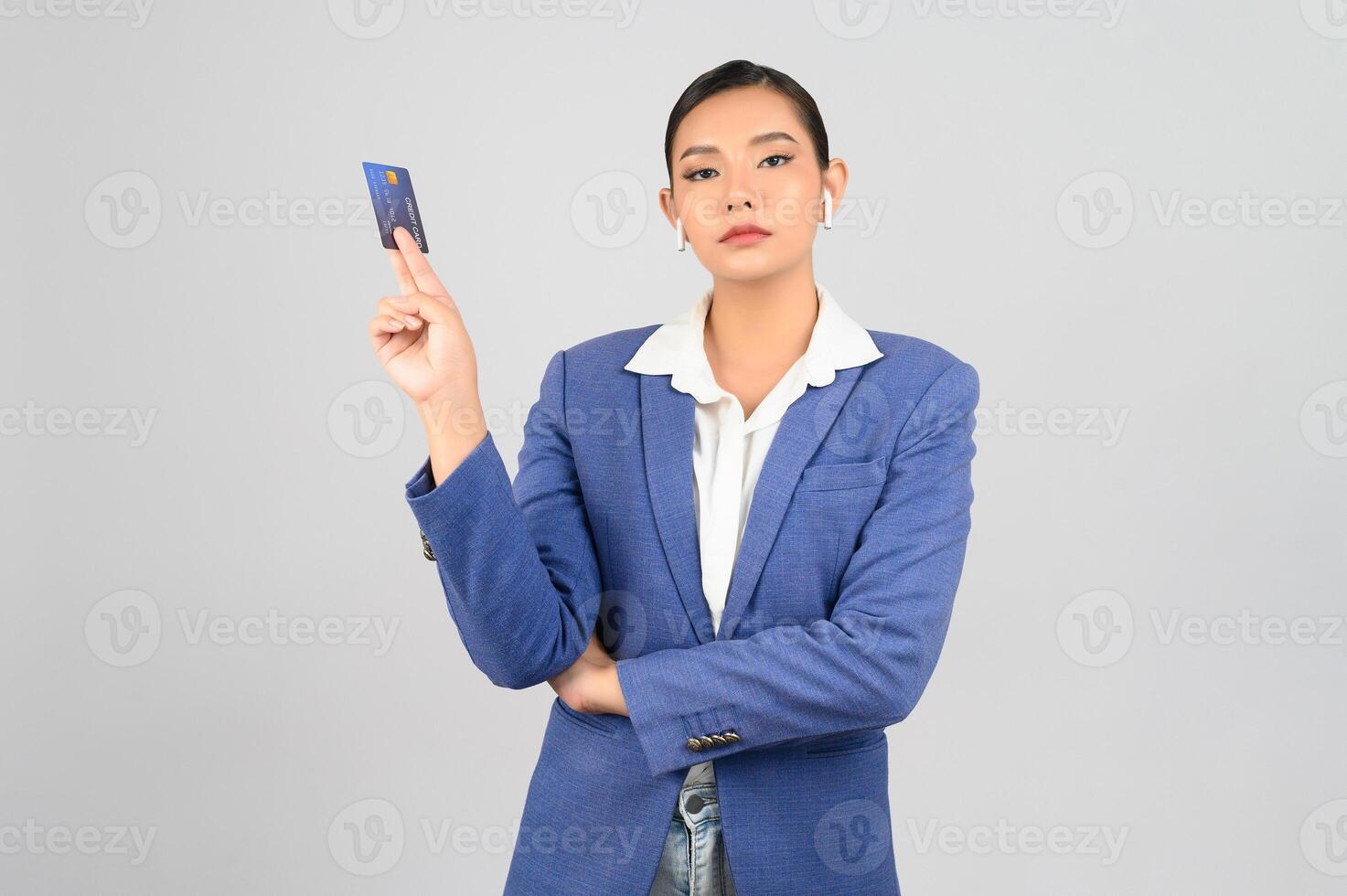 Young beautiful woman in formal clothing for officer with credit card photo