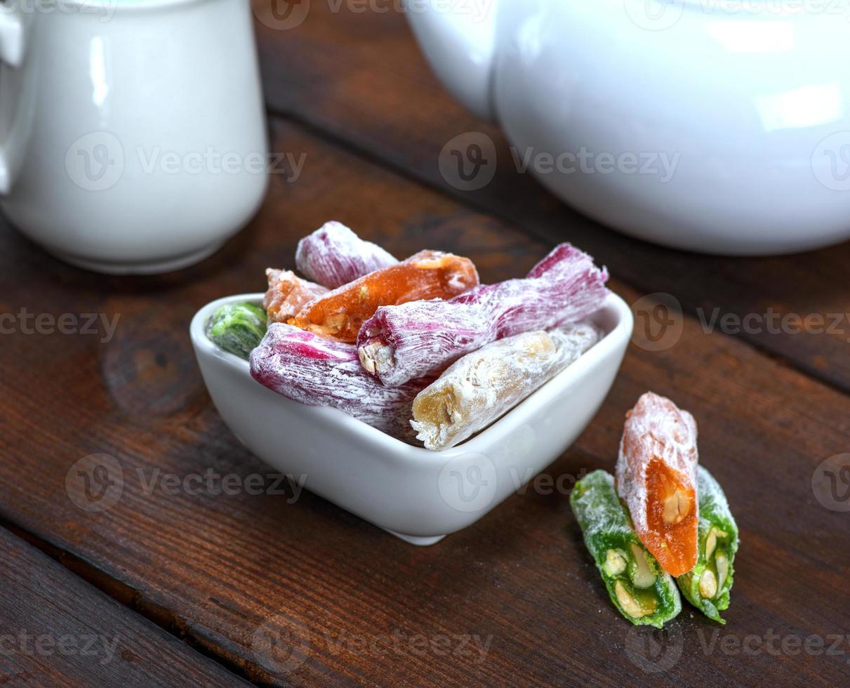 Turkish delight with nuts in a ceramic bowl photo