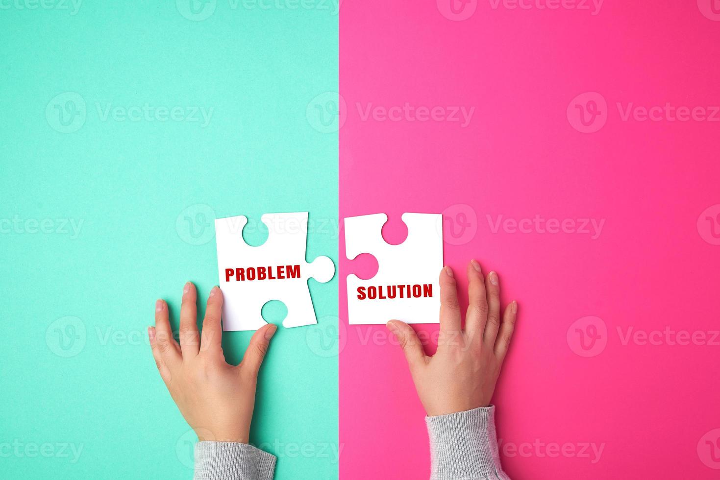 two empty paper white pieces of puzzles in female hands, puzzle connected photo