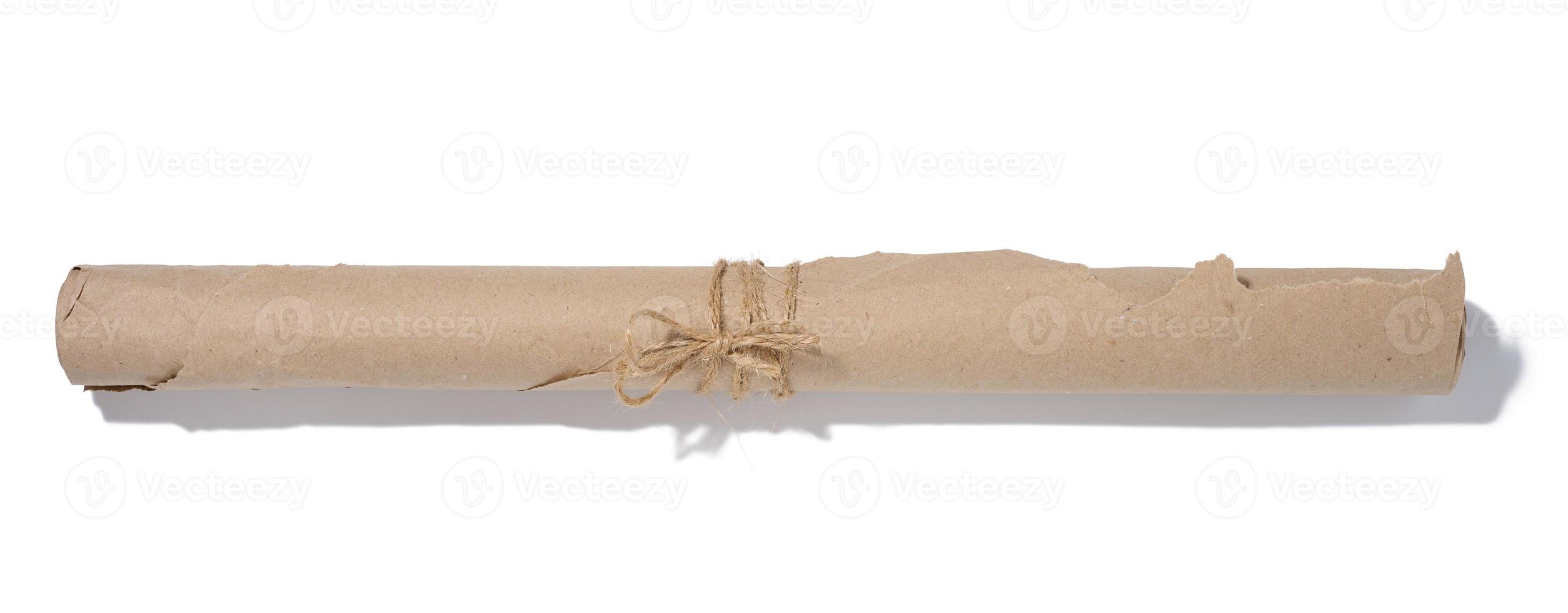 Twisted brown wrapping paper in a roll and tied with a rope on a white background photo