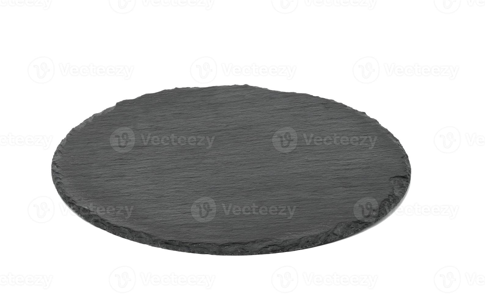 empty black round graphite board for serving dishes isolated on white background photo