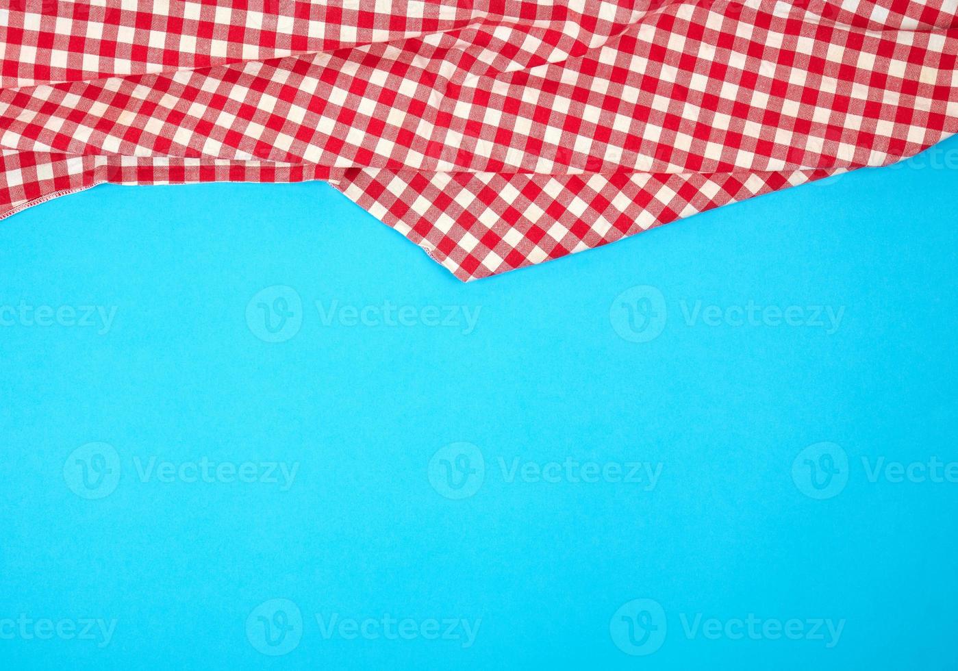 white red checkered kitchen towel on a blue background, bright picnic background photo