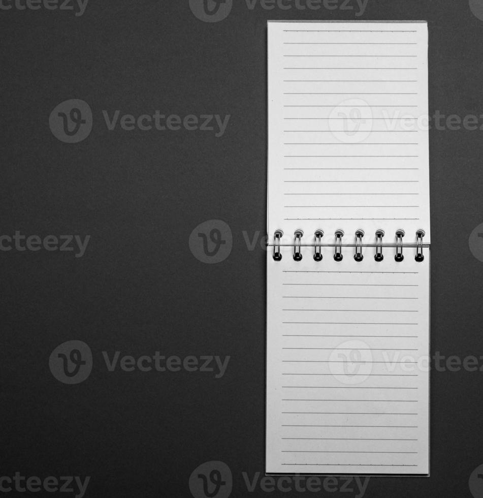 Blank open notebook in a line on a black background photo