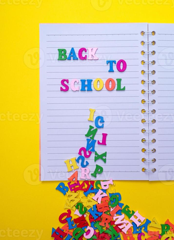 inscription back to school on a white notebook photo