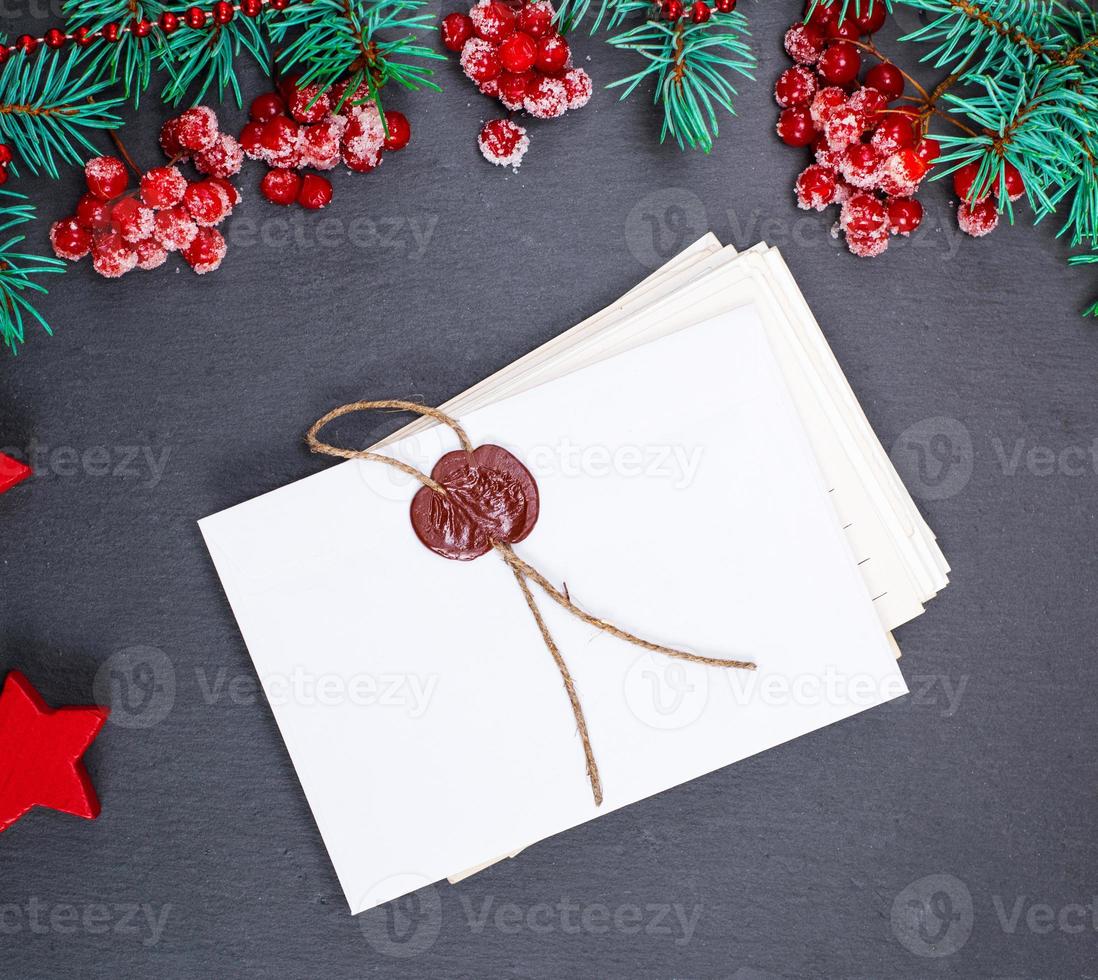 empty white paper covert sealed and green spruce branches photo