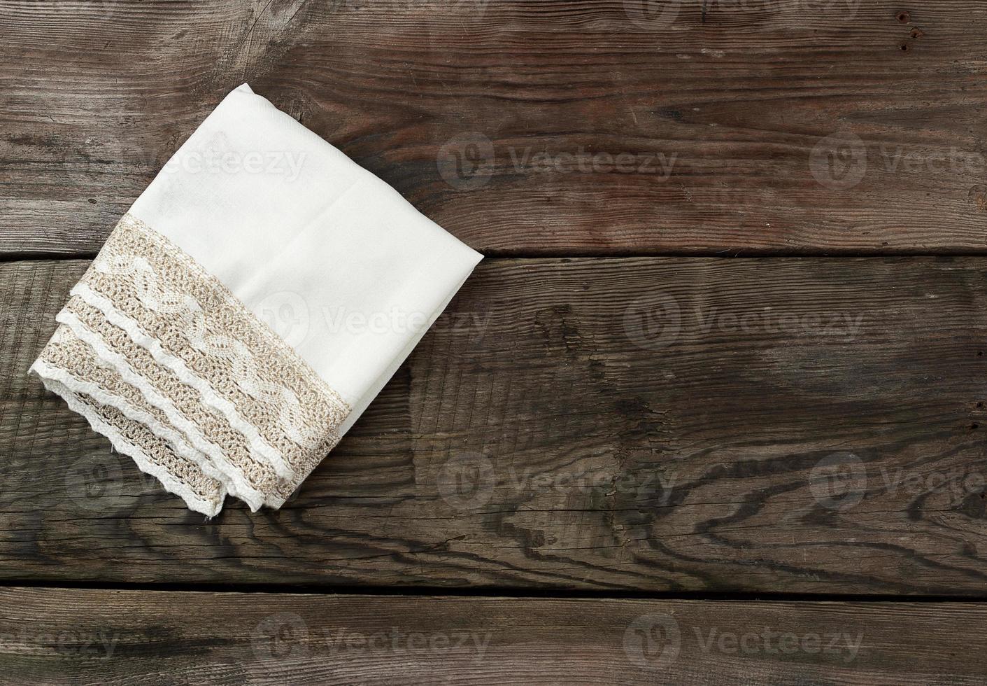 white napkin, kitchen wooden background in vintage style photo