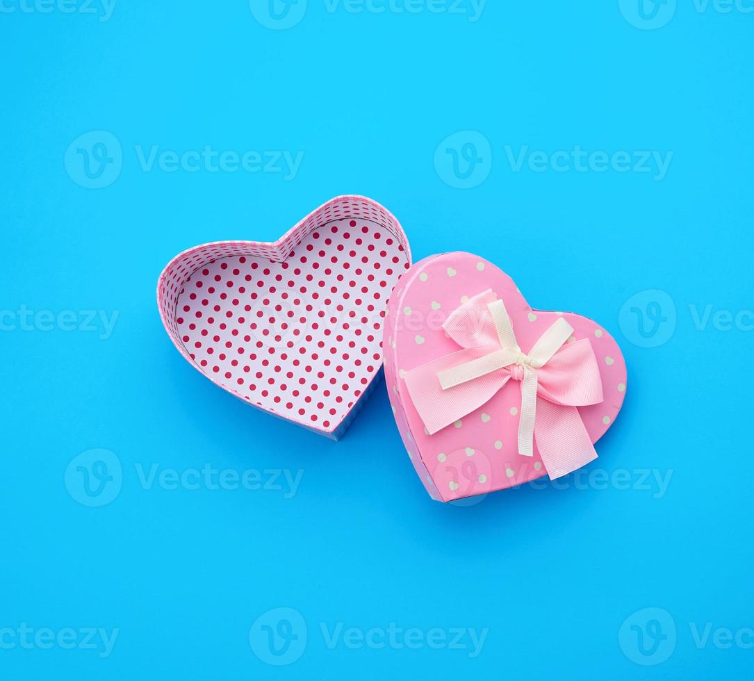 open empty cardboard box in the form of a heart on a light blue background photo