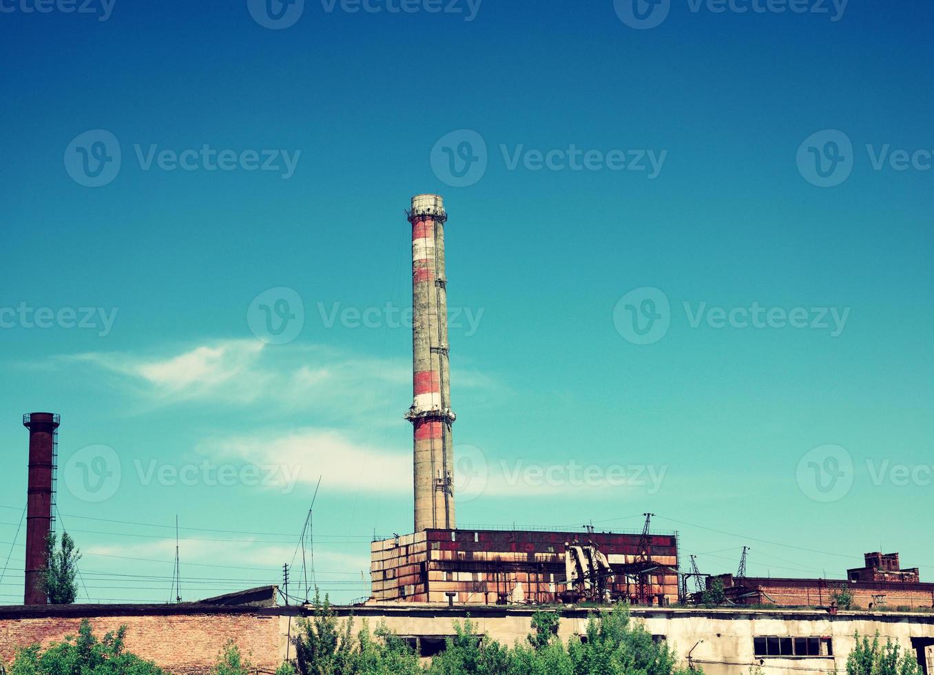 Brick pipe abandoned factory against the sky photo