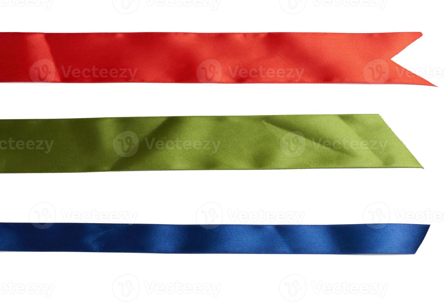 set of multicolored silk ribbons on white background. View from above photo