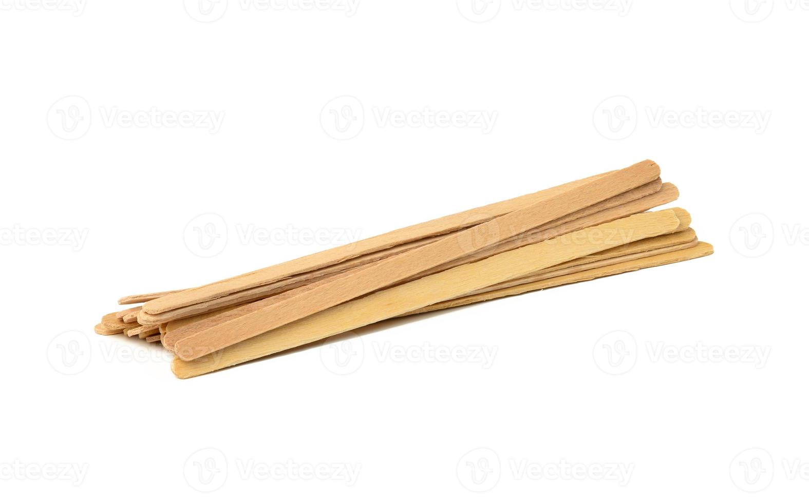 disposable wooden sticks for stirring hot drinks isolated on white background. Coffee and tea spoon, zero waste photo