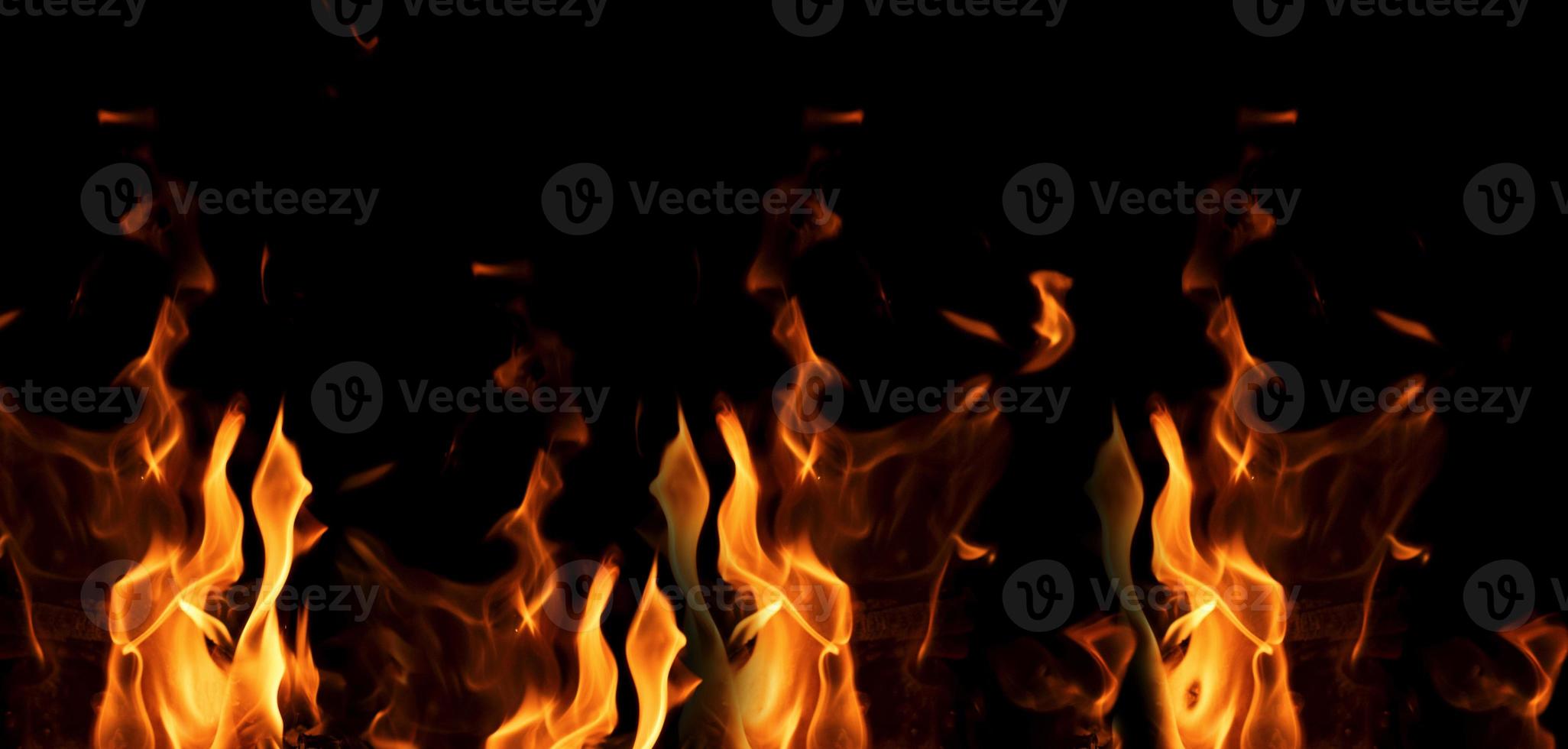 bright orange and yellow flames on a black background photo