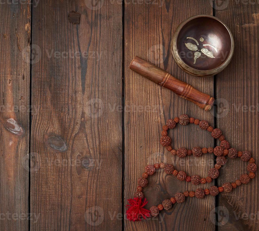 singing Tibetan copper bowl and wooden stick photo