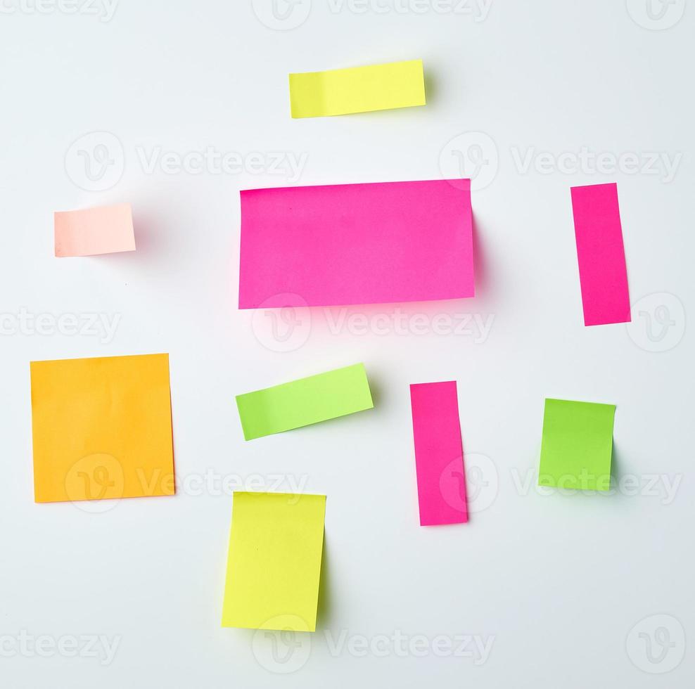 various blank paper multicolored stickers on a white wall photo