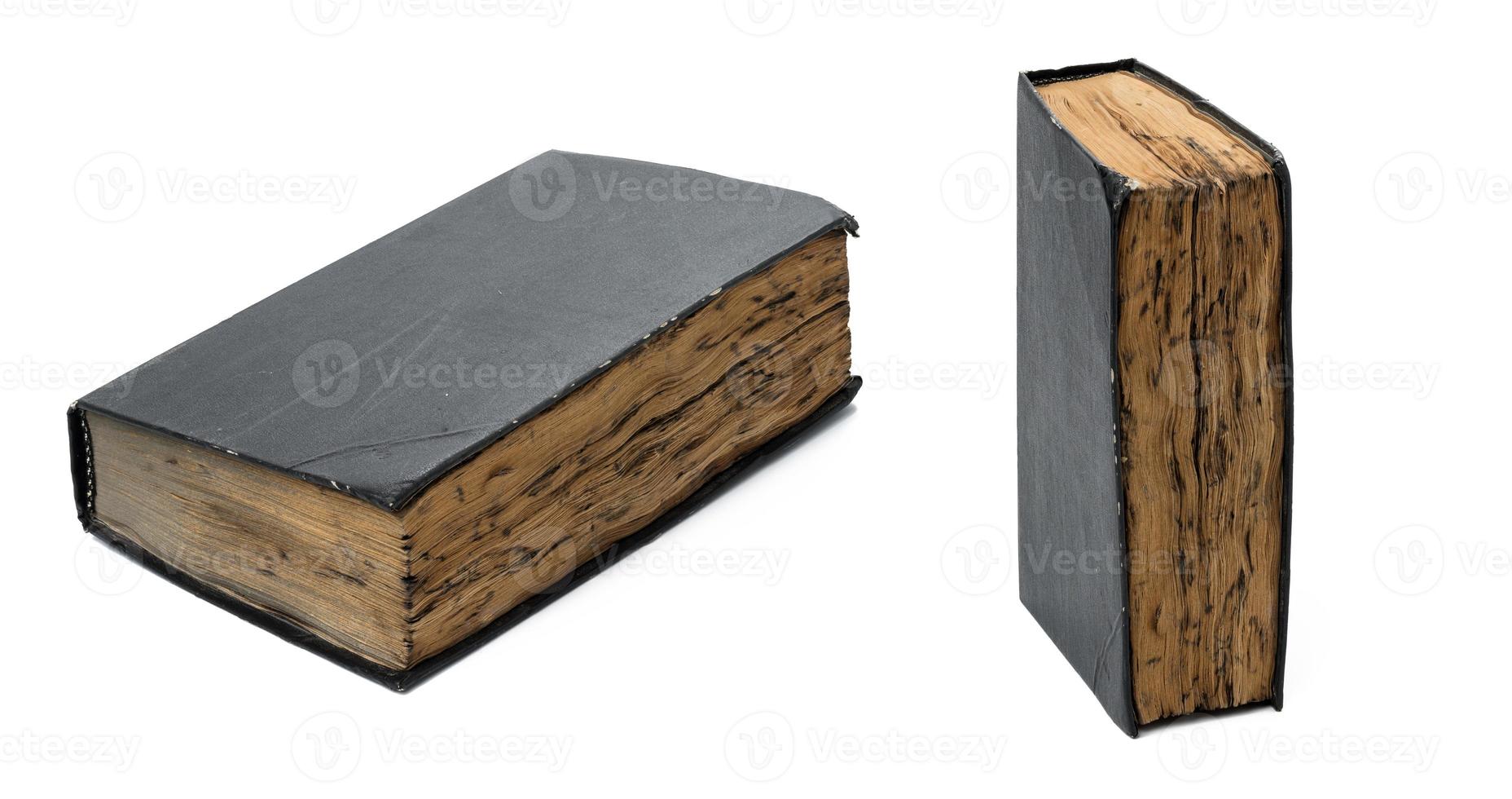 very old book with burnt sheets and a black shabby cover on a white isolated background photo