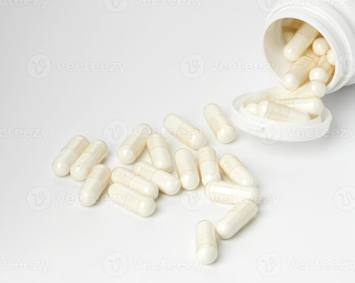 medical powder in white capsules on a white background. Treatment pills photo