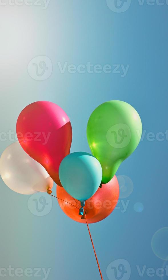 Multicolored balloons against the sky photo