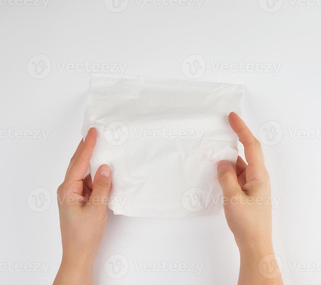 facial tissue in female hands over white background photo