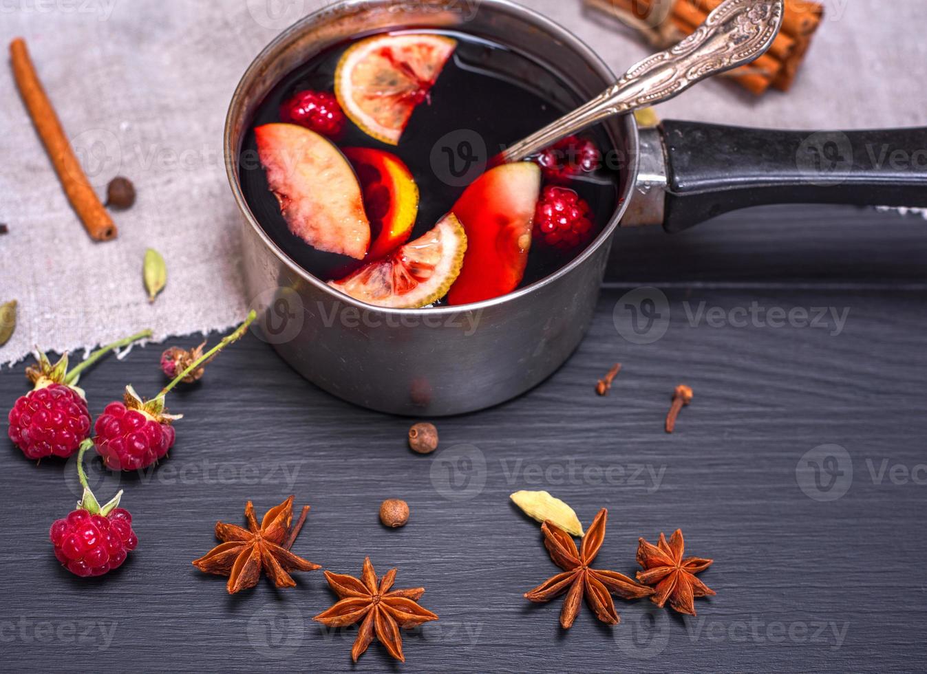 mulled wine in an aluminum ladle with a handle photo