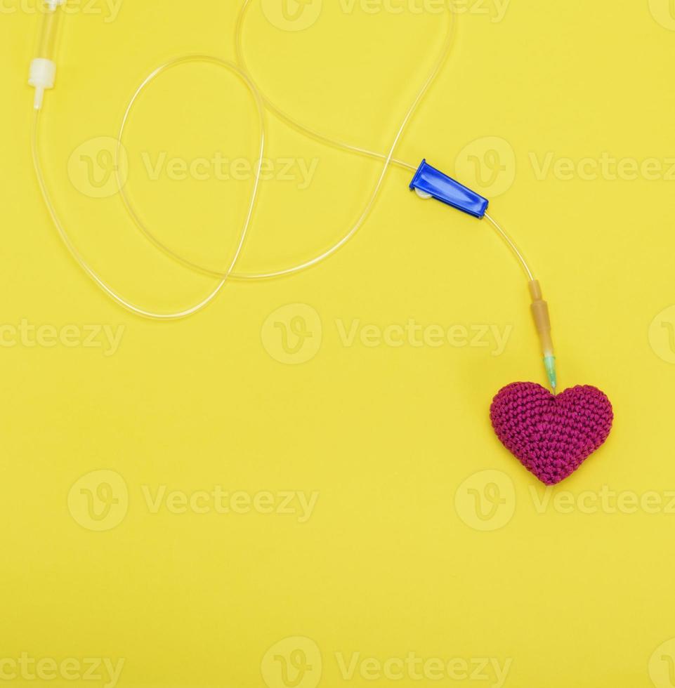 plastic catheter with needle and red heart photo