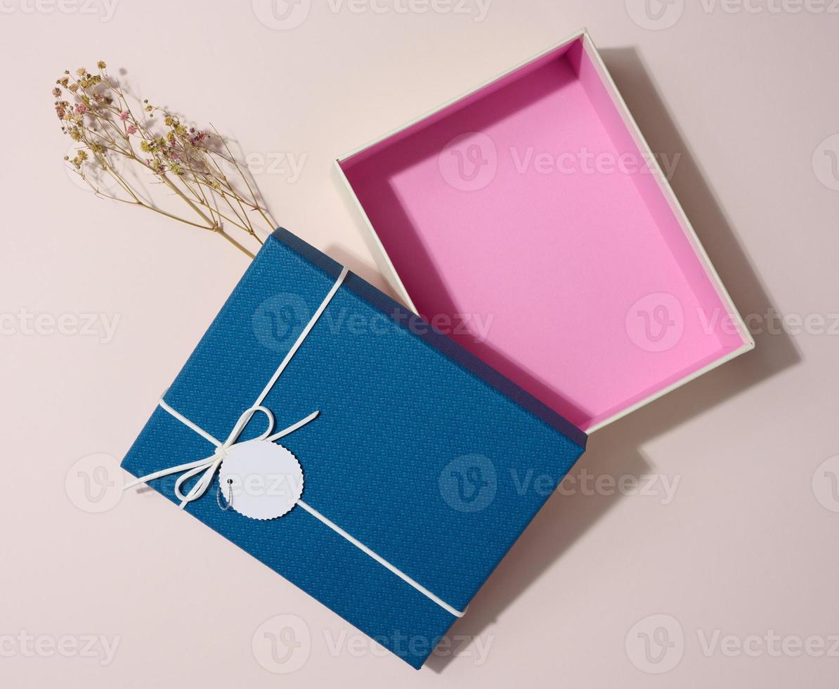 Empty open rectangular gift cardboard box on beige background, top view photo
