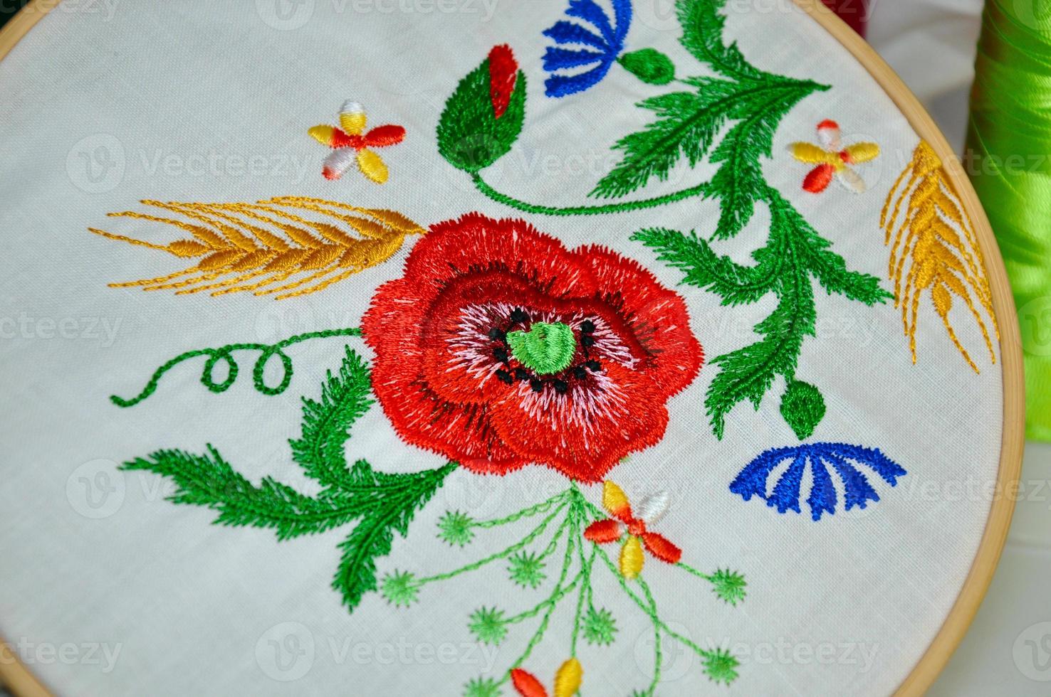 Detail of embroidery flower ornament in wooden hoop photo