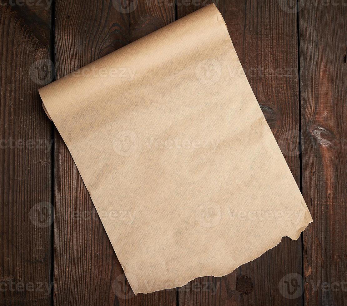 roll of untwisted brown paper on a wooden surface from old boards photo