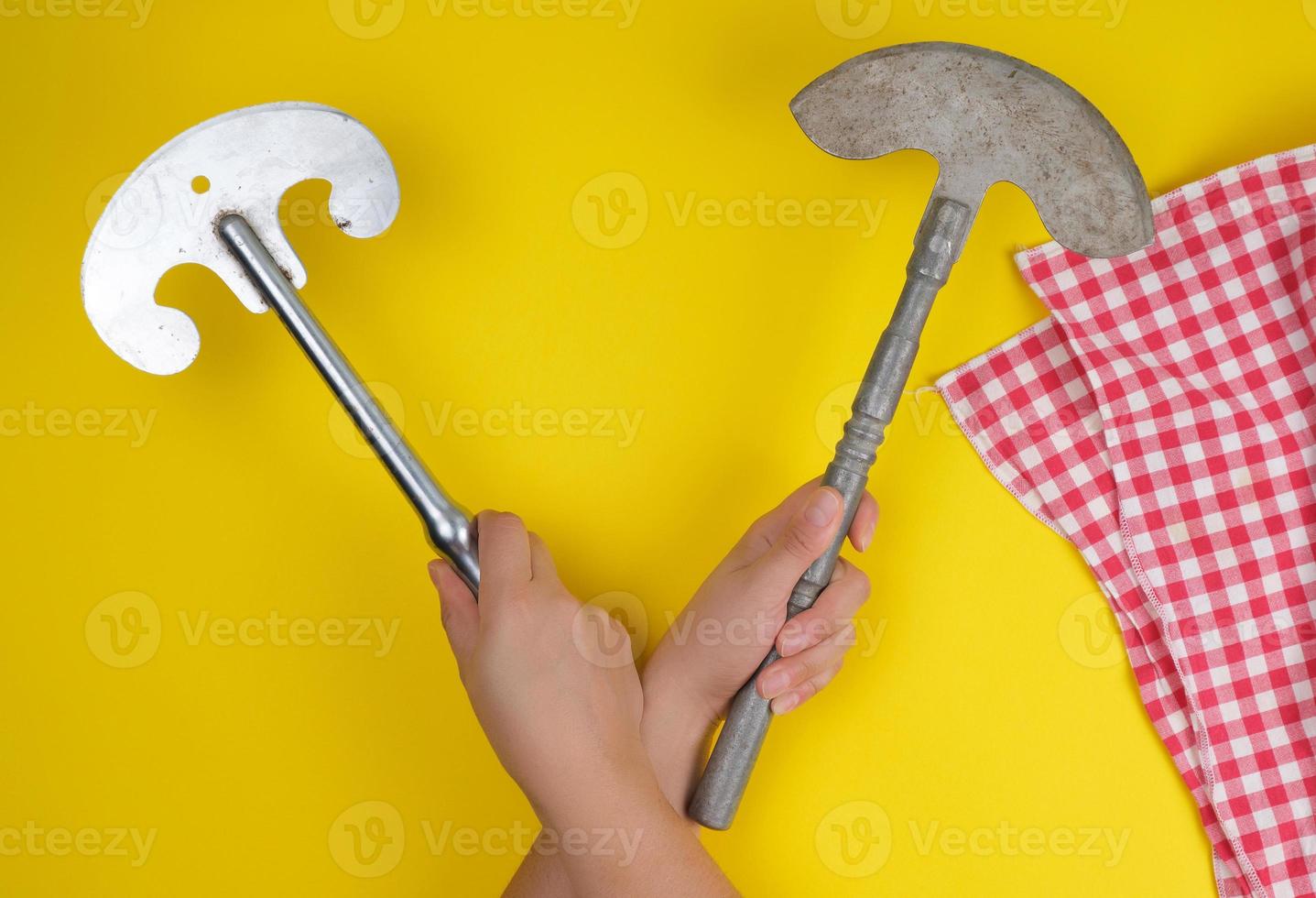 two hands holding vintage sharp kitchen knives for meat and vegetables photo