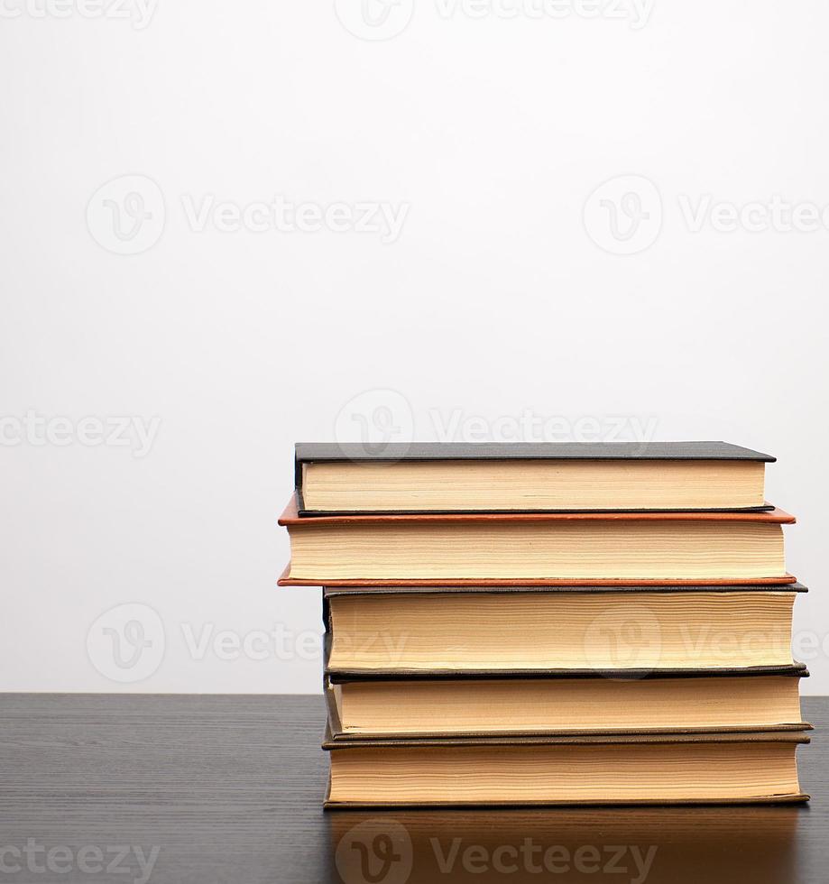 stack of books on a black table, white background photo