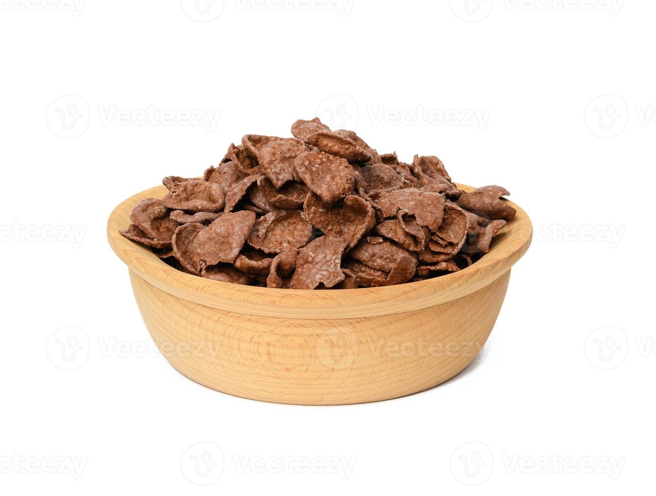 chocolate cornflakes in wooden plate isolated on white background photo