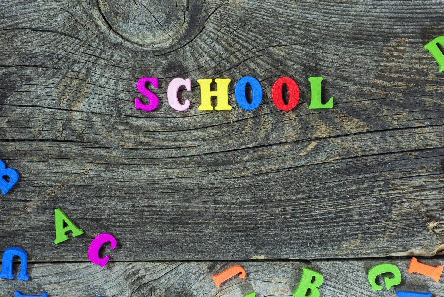 Wooden multicolored letters on a gray surface photo