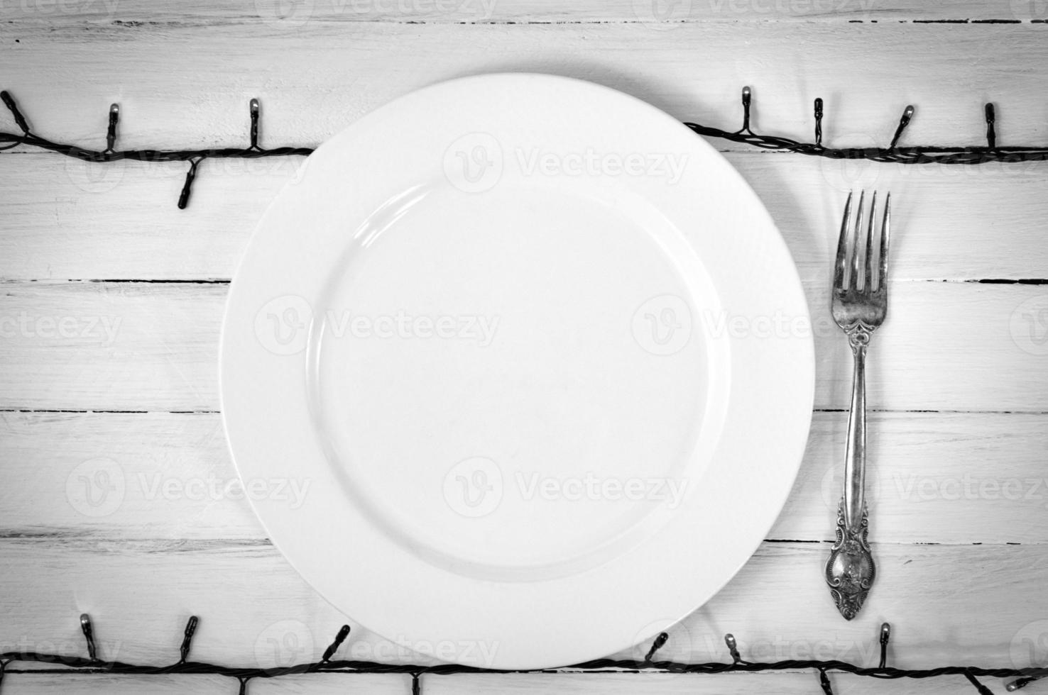 White empty plate with a fork photo