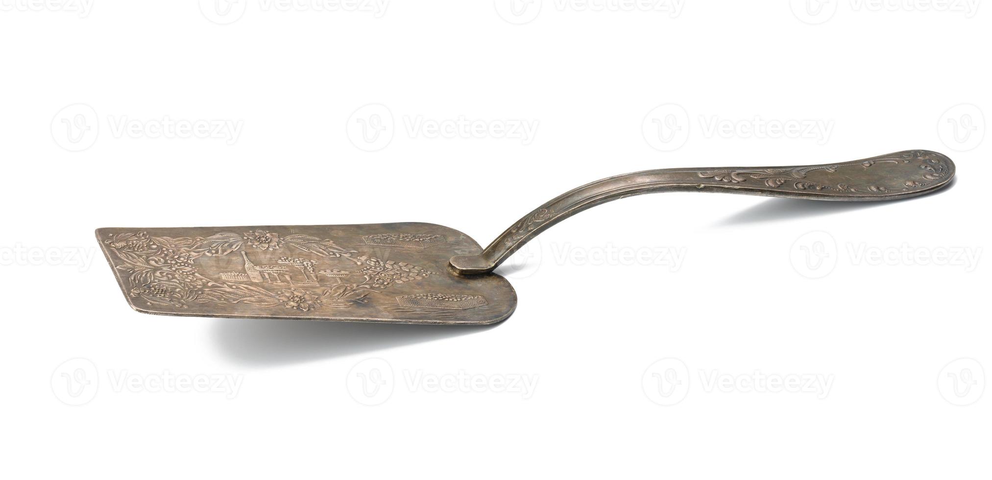 vintage metal spatula for dessert on a white isolated background photo