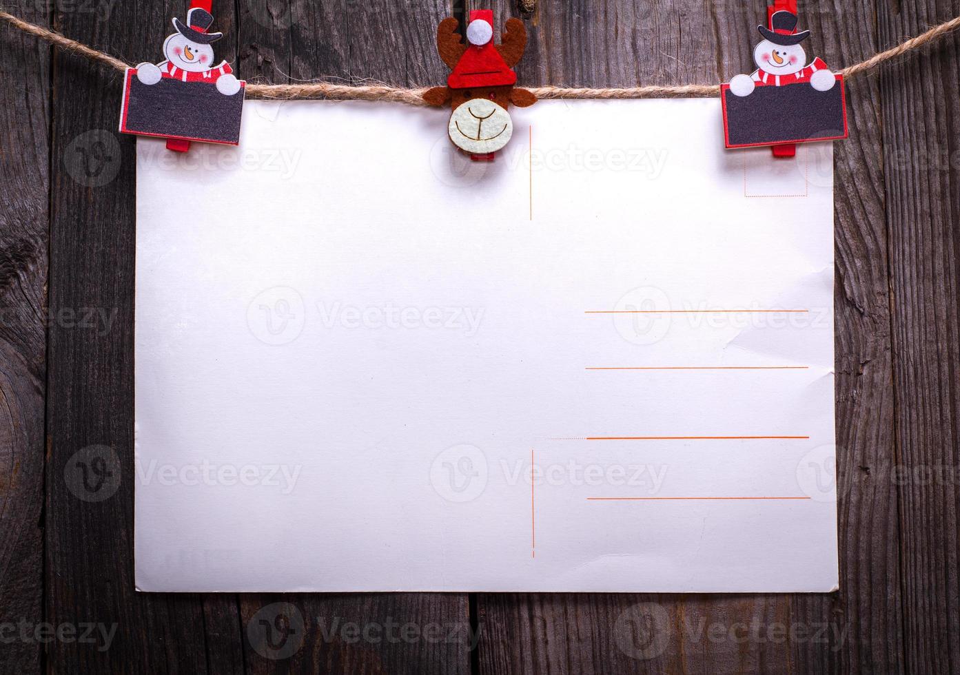 old paper postcard hanging on a rope photo