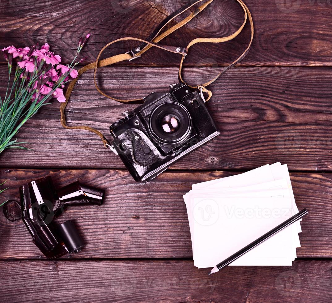 Old vintage film camera in a leather case photo