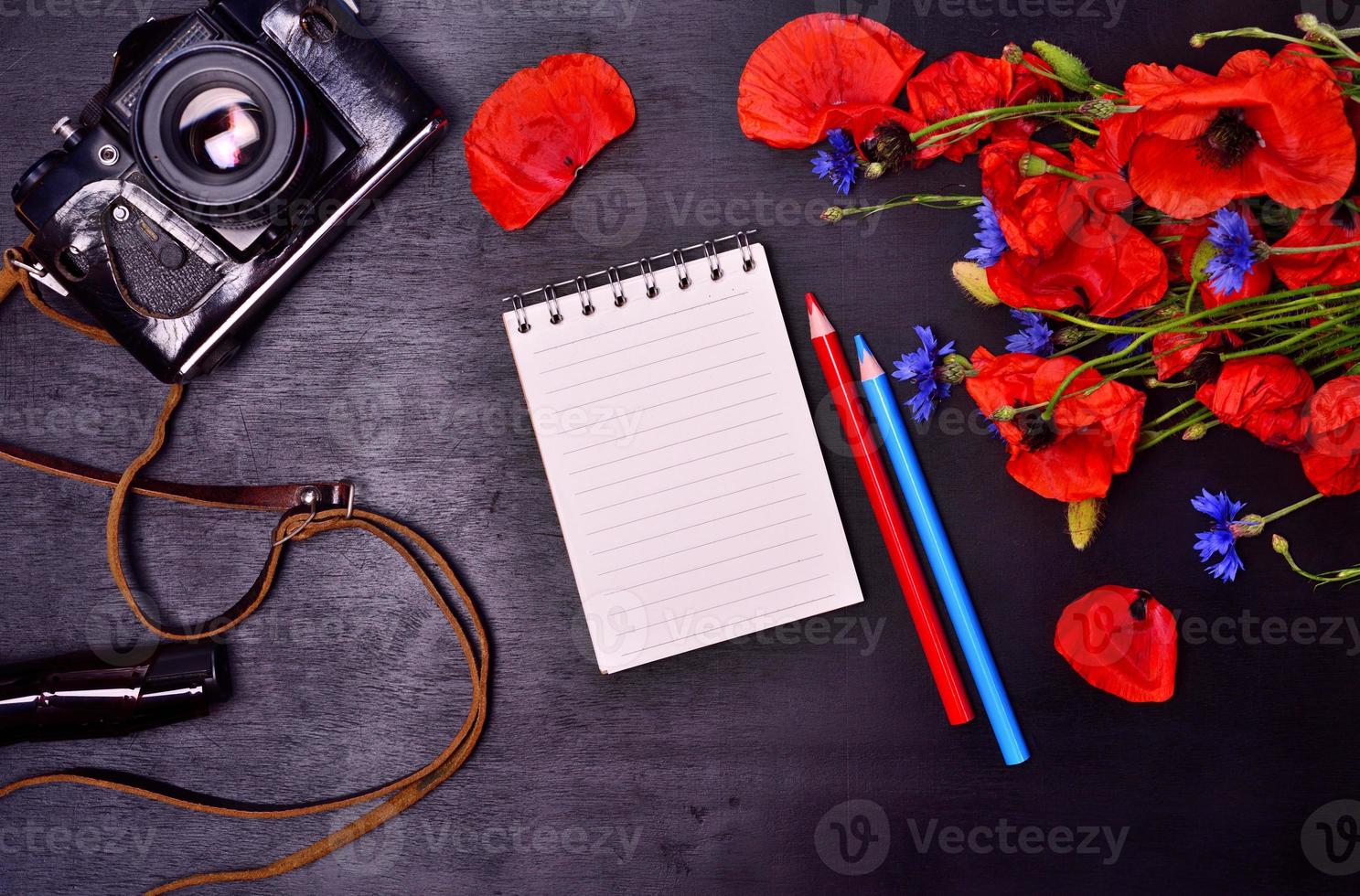 Pencil notepad and vintage film camera photo