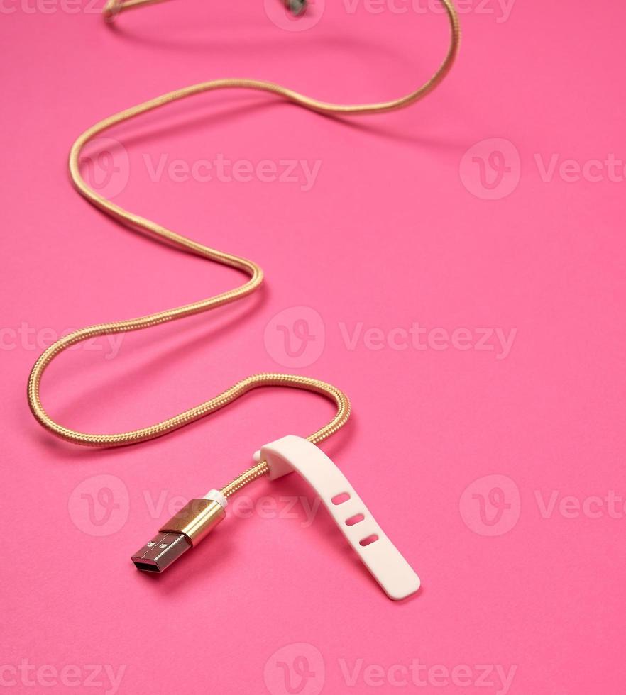 golden usb cable for charging with electricity equipment in textile winding photo