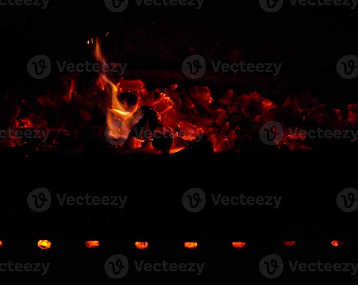 burning wooden logs in the fire at night photo