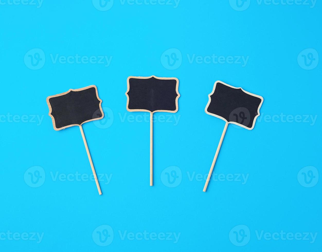 wooden pointer on a stick for writing text, blue background photo