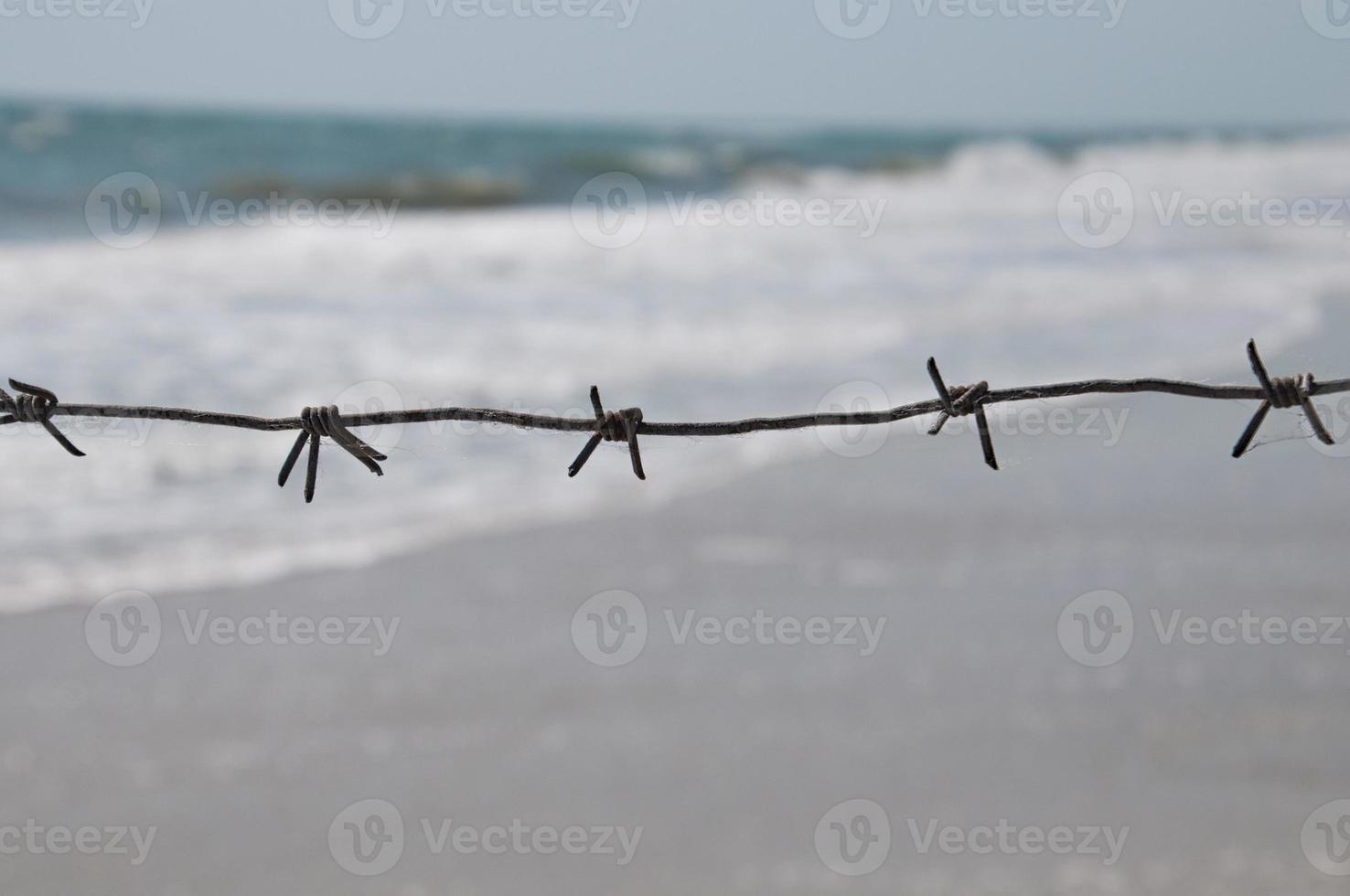 Iron rusty wire against the sea photo