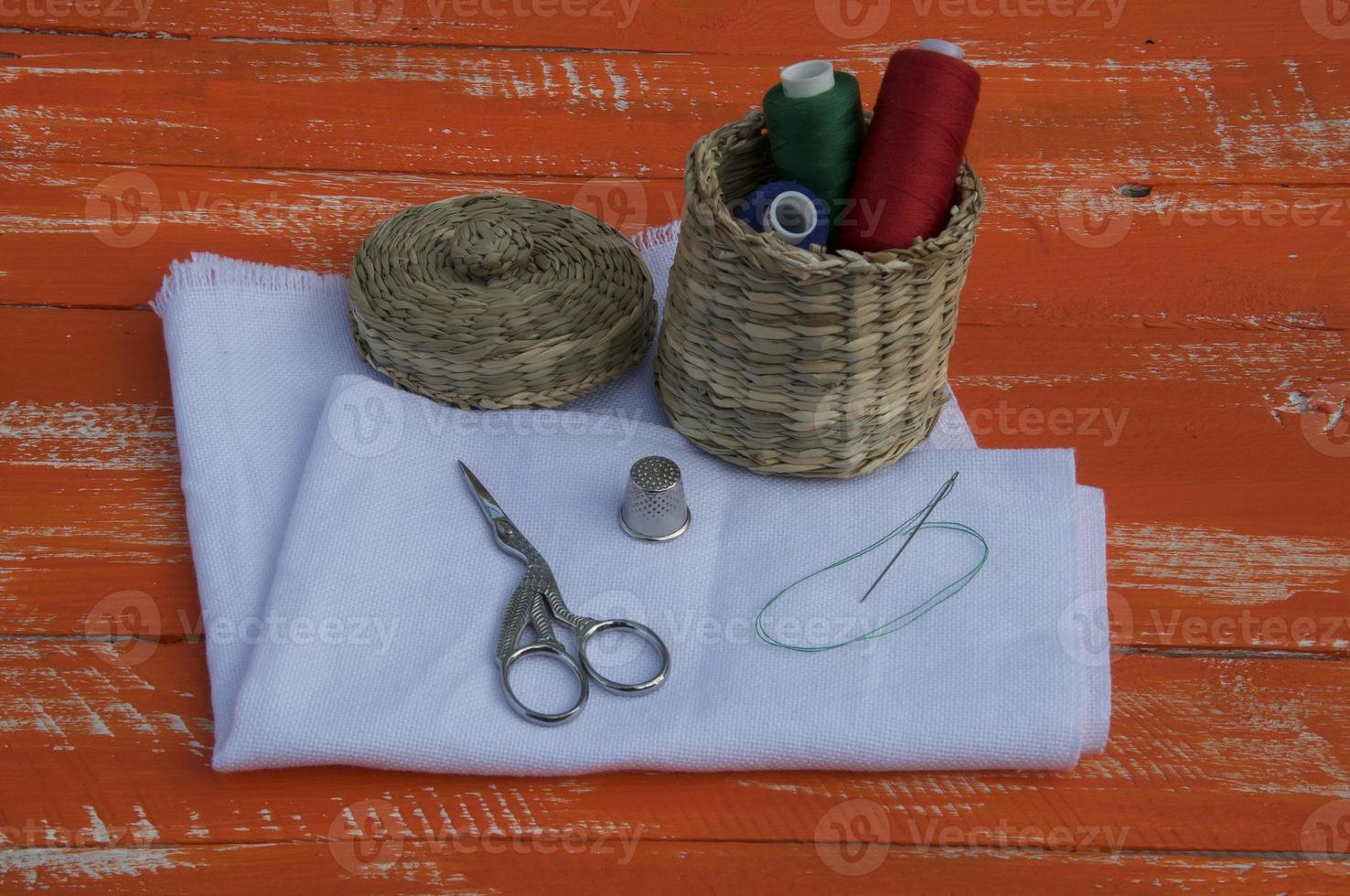 Fabric with objects for sewing and embroidery, orange tone photo