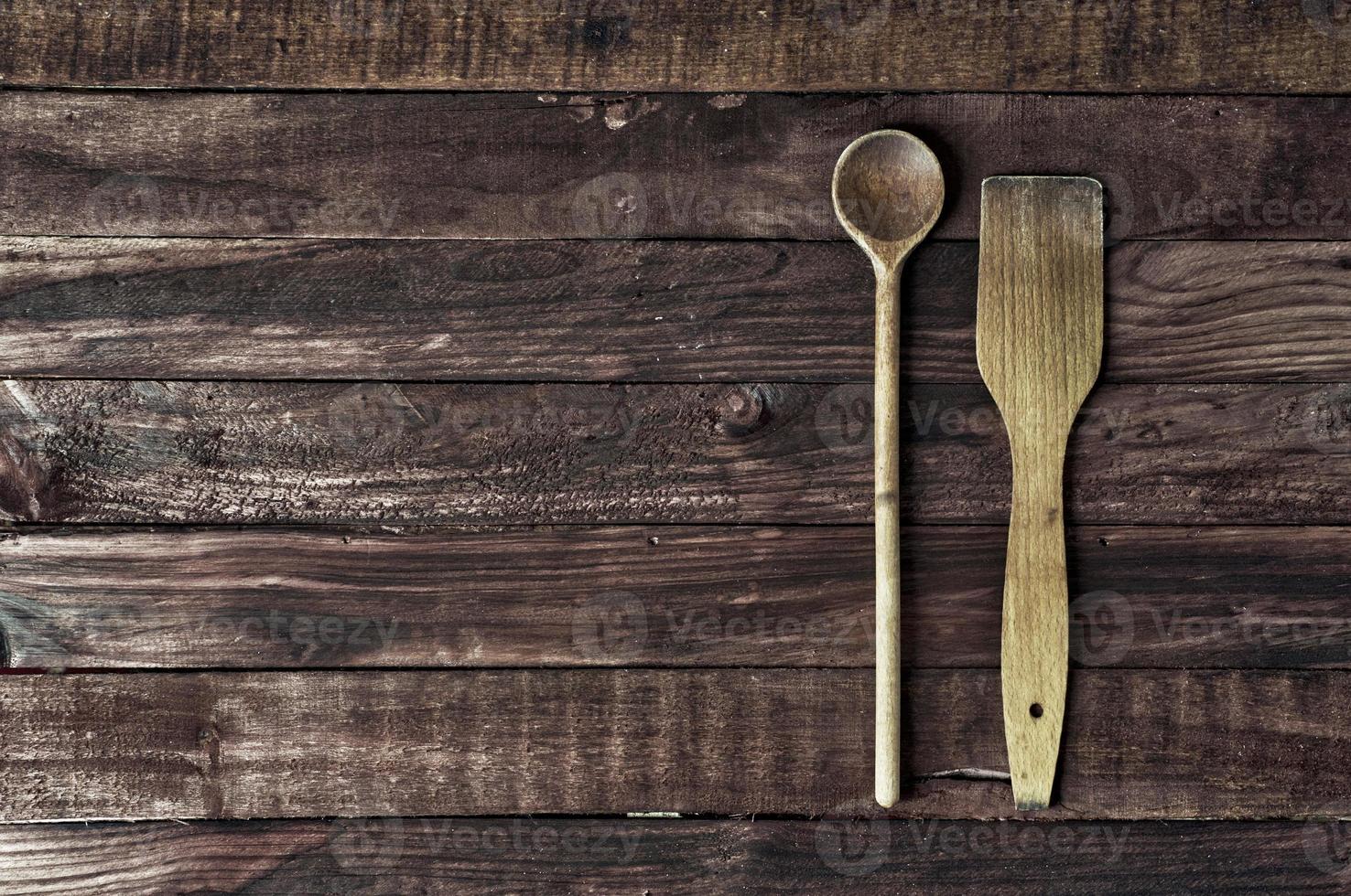 wooden kitchen spatula and a spoon on a brown surface photo