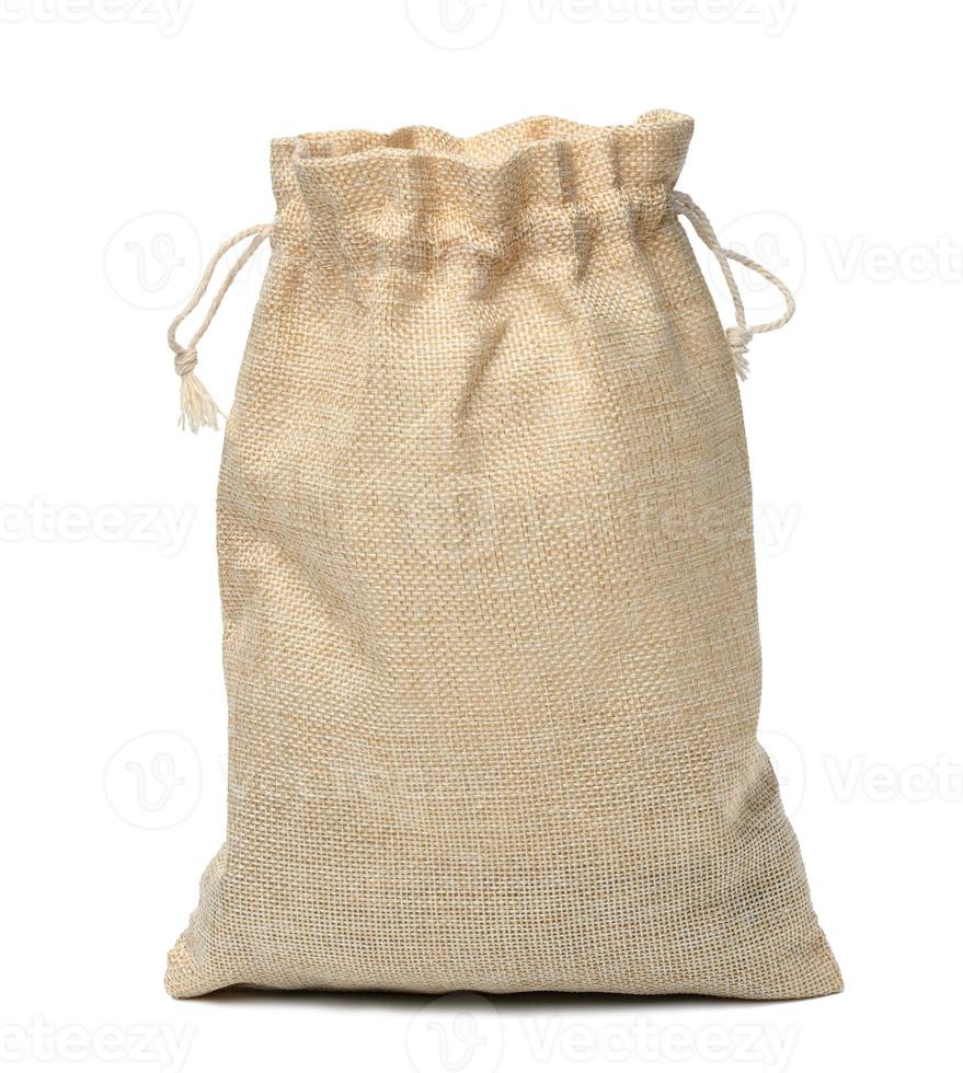 Full canvas bag tied with rope and isolated on a white background photo