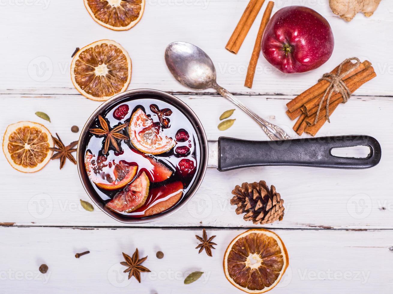 mulled wine with spices and fruits in an aluminum container photo