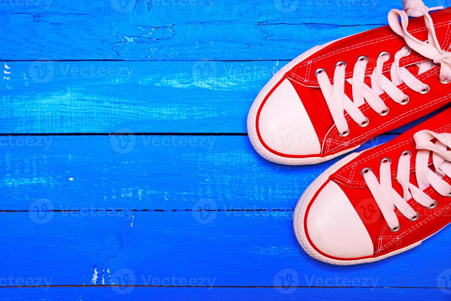 A pair of bright red textile sneakers photo