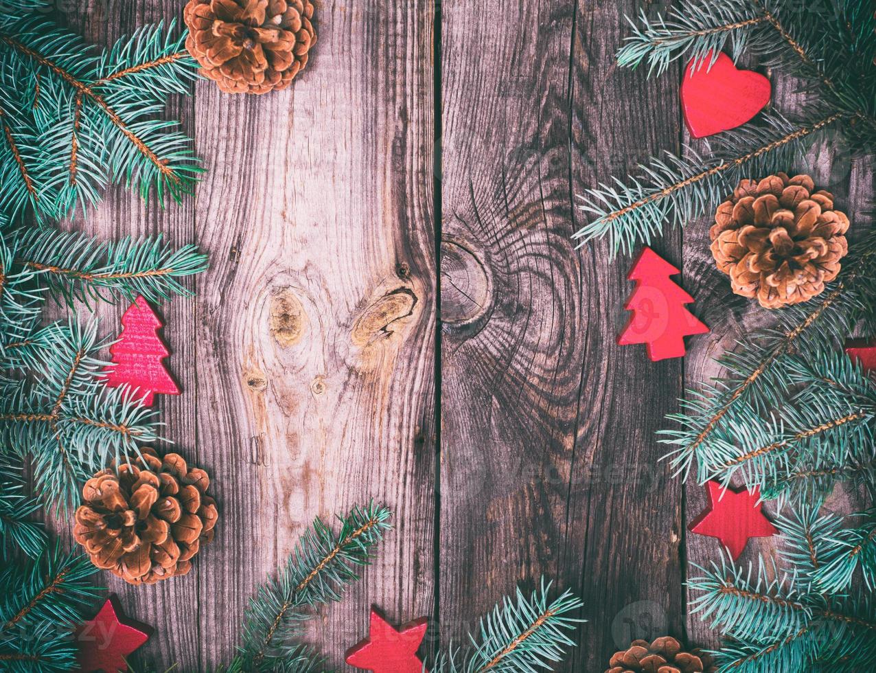 gray wood background with green spruce branches and Christmas decor photo