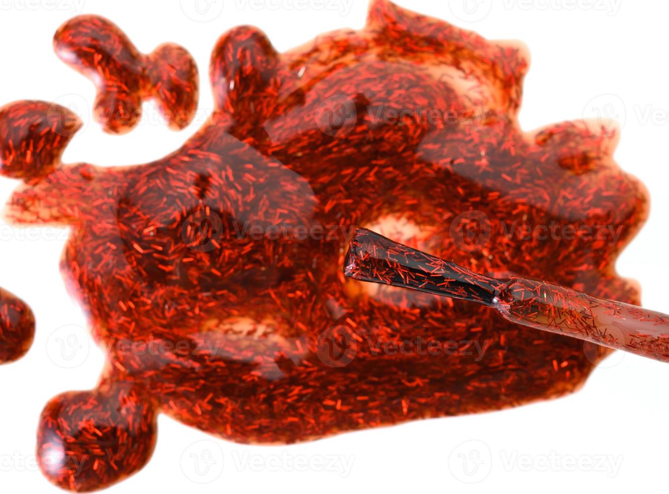 spilled red nail polish with sparkles and a brush on a white background, blot photo
