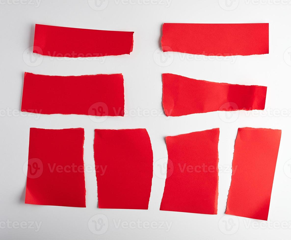 various blank pieces of red paper on white background photo