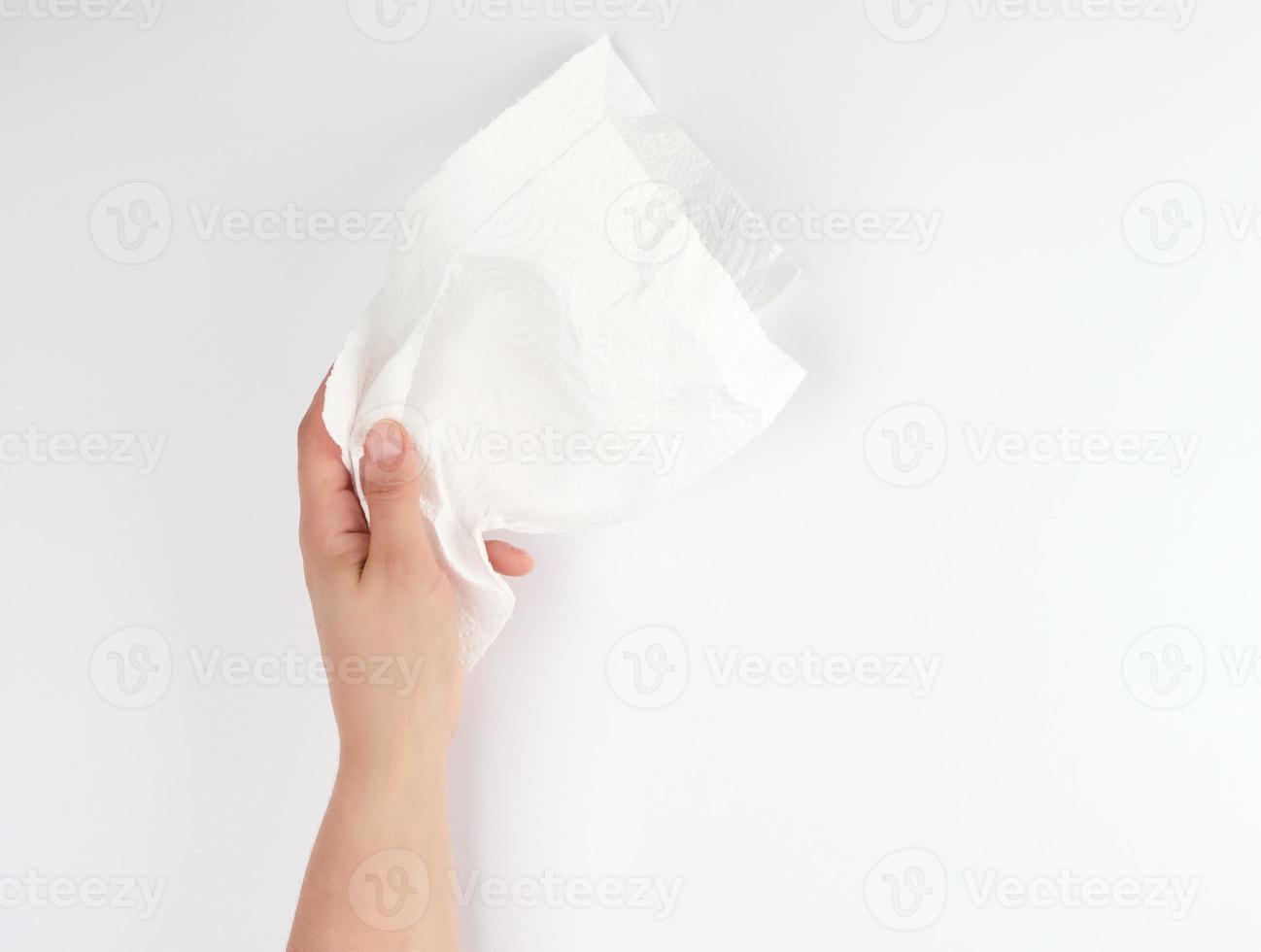 female hand holding a clean white paper napkin photo