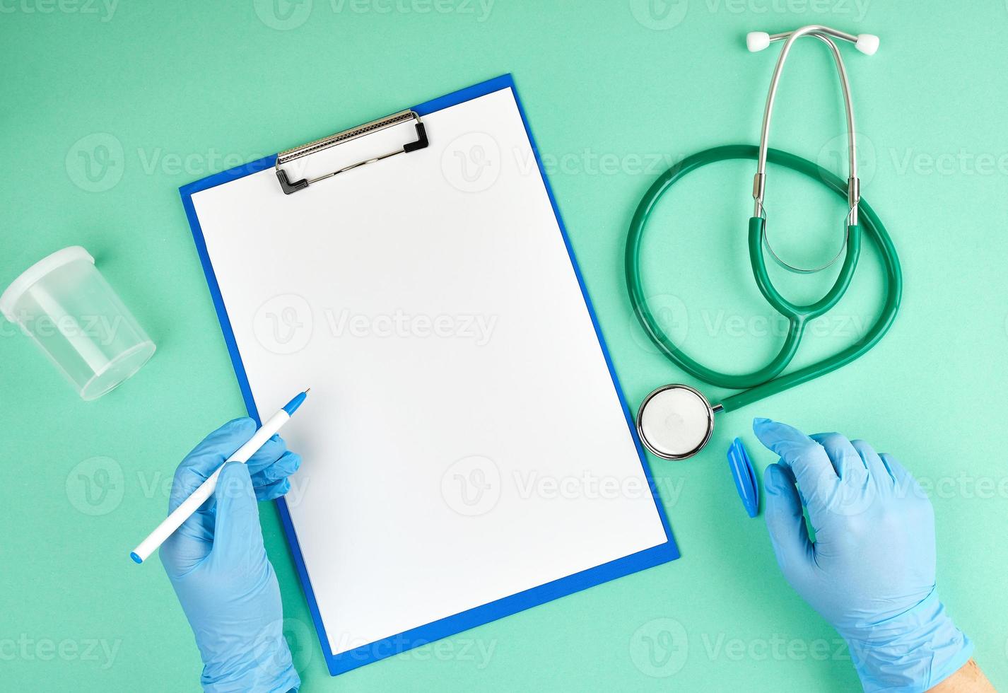 female hand in blue sterile gloves and medical stethoscope photo