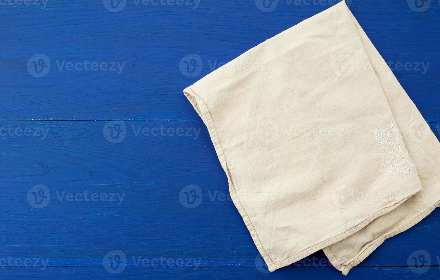 white kitchen textile towel folded on a blue wooden table from old boards photo